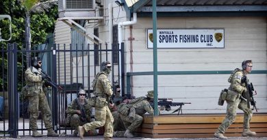 Royal Military College Staff Cadets approach the Whyalla Sea Rescue Centre to clear a 'hostile enemy'. Photo by Sergeant W Guthrie.