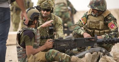 Australian Army soldier Lance Corporal Victor Terron provides marksmanship tips to Iraqi Army Rangers during the .50-cal machine gun live fire at the Besmayah Range, Iraq. Photo by Able Seaman Chris Beerens.