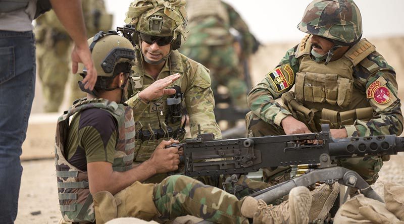 Australian Army soldier Lance Corporal Victor Terron provides marksmanship tips to Iraqi Army Rangers during the .50-cal machine gun live fire at the Besmayah Range, Iraq. Photo by Able Seaman Chris Beerens.