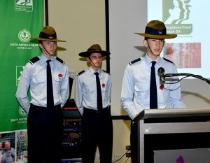 Cadet Ethan O’Connor gives an address during a Remembrance Day event, supported by Cadets Joshua Duncan and Darcy Needle.