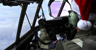 Royal Australian Air Force Flight Lieutenant Omar Rigo, 37 Squadron pilot, flies a Royal Australian Air Force C-130J Hercules toward Micronesian islands during Operation Christmas Drop. US Air Force photo by Staff Sergeant David Owsianka.