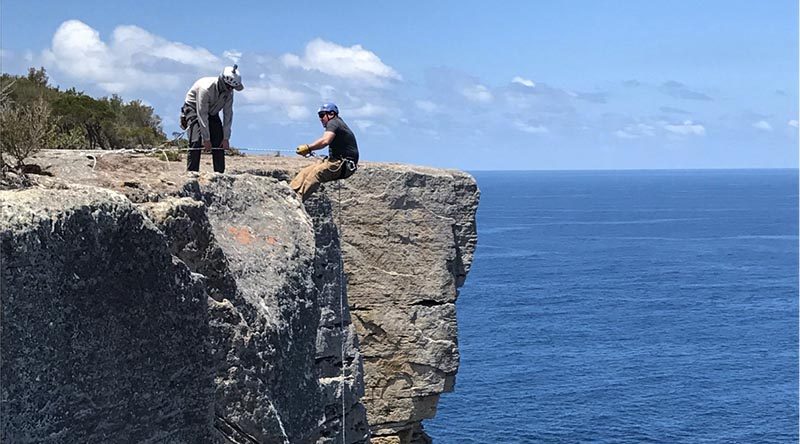 Officer Commanding Adventurous Training Wing Major Dan Fussell encourages an Ex BB participant on an abseil.