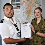 Jimmy from Flight Training Adelaide presents a certificate to Leading Cadet Jade Curwood of No 613 Squadron, AAFC.