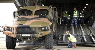 RAAF Base Amberley Air Movements personnel guide Australian Army WO2 James Moss as he reverses a Hawkei into a C-17A Globemaster. Photo by Corporal Ben Dempster.