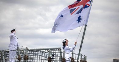 Able Seaman Samuel Millar and Able Seaman Alice Saunders lower HMAS Darwin’s Australian White Ensign for the last time. Photo by Leading Seaman Kayla Hayes.