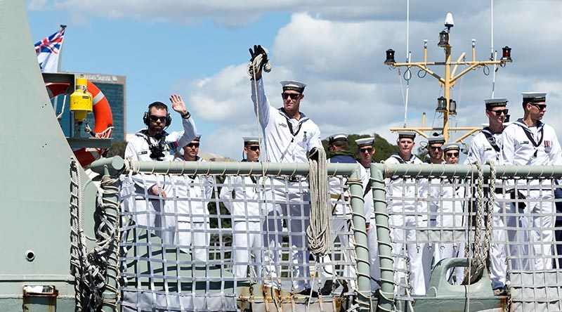 HMAS Newcastle' sailors wave to families as she pulls alongside Garden Island, Sydney after returning home from the Middle East Region. Photo (and caption) by Able Seaman Craig Walton.