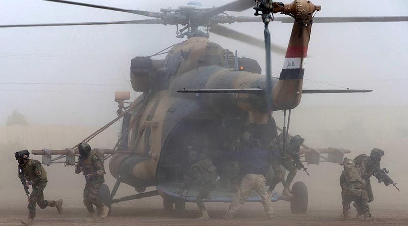 Iraqi Army Rangers disembark from an Iraqi Army MI-17 helicopter during the Rangers' certification activity at the Taji Military Complex, Iraq. Photo by Corporal Steve Duncan.