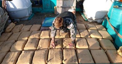 Leading Seaman Clearance Diver Luke Woodcroft from HMAS Warramunga numbers parcels of seized narcotics on the deck of a trafficking vessel. Photo by Leading Seaman Tom Gibson.