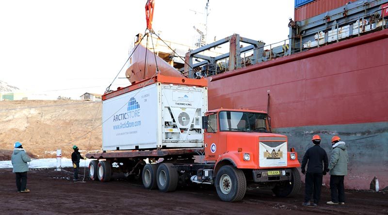 A shipping container with up to 28 tonnes of supplies is hoisted on to a truck driven by a New Zealand Defence Force driver. NZDF photo.