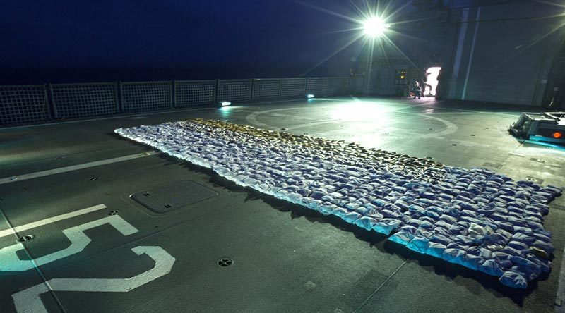 Seized parcels of heroin lay on the flight deck of HMAS Warramunga during an operation in the Western Indian Ocean. Photo by Leading Seaman Tom Gibson.