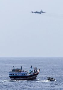 A Royal New Zealand Air Force P-3K2 Orion flies past HMAS Warramunga’s boarding team during an operation in the Western Indian Ocean. Photo by Leading Seaman Tom Gibson.