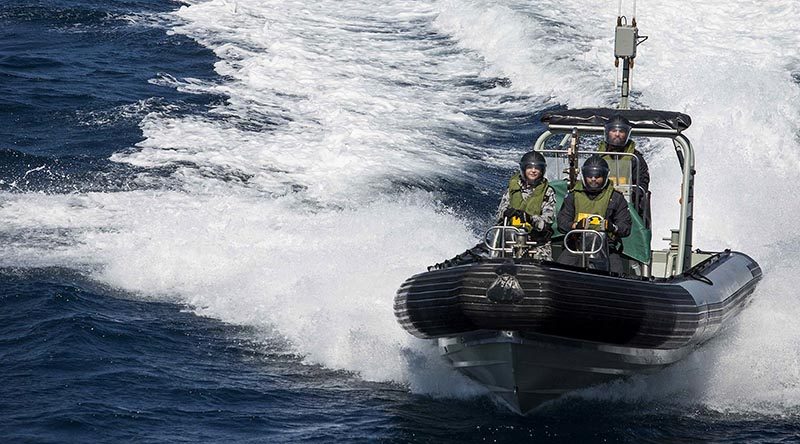 Able Seaman Combat Specialist Daniel Peihopa, RNZN drives one of HMAS Warramunga’s sea boats with Leading Seaman Combat Specialist Te Orangapumau Elia, RNZN (right) and Able Seaman Boatswains Mate Bridget Hopkins (left) during Warramunga's deployment to Operation Manitou. Photo by Leading Seaman Tom Gibson.