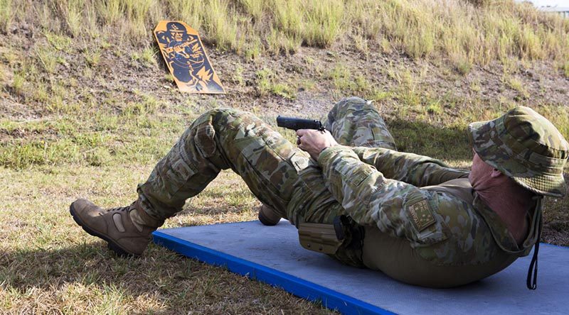 A RAAF Officer practices alternate firing positions with a pistol as part of the ISET-Tactical training aimed at improving his individual combat skills. Photos by Sergeant Amanda Campbell.