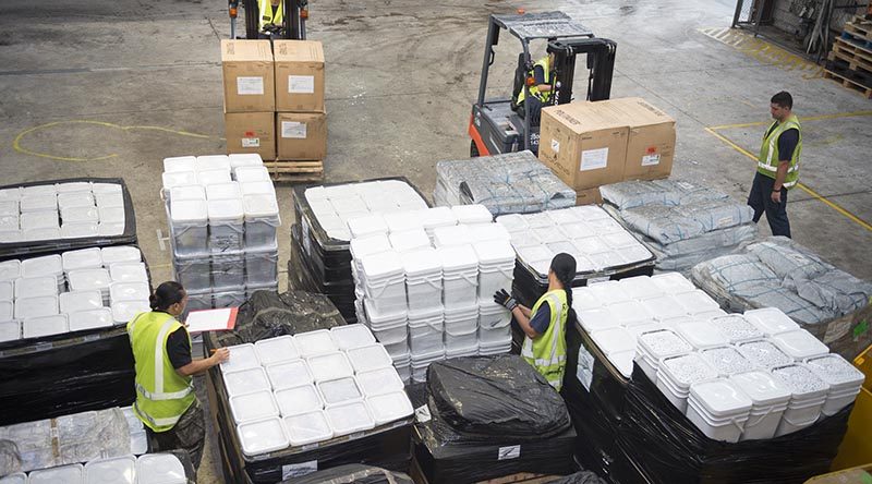 New Zealand Defence Force personnel prepare to load 12 tonnes of aid supplies for cyclone-hit Tonga. NZDF photo.