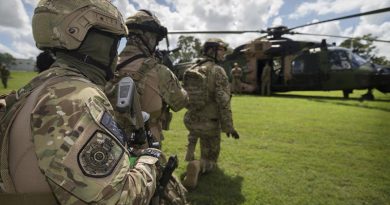 Queensland Police Service Special Emergency Response Team tactical operators await the all-clear signal during familiarisation drills with an Australian Army MRH90 helicopter in preparation for the 2018 Commonwealth Games. Photo by Sergeant W Guthrie.