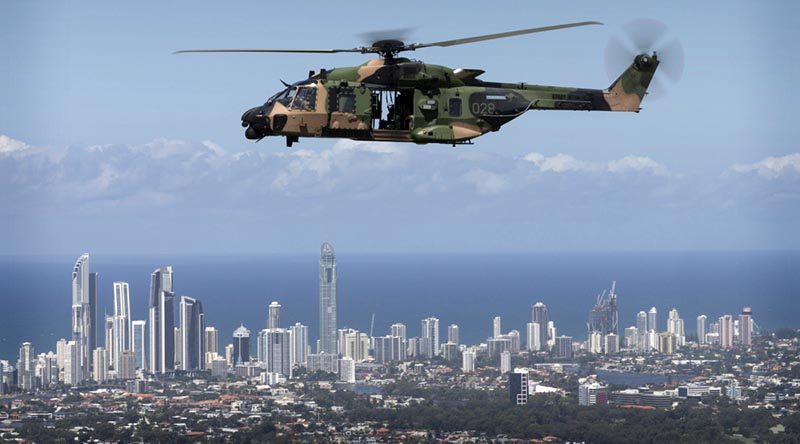 An Australian Army MRH-90 helicopter takes Queensland Police Service Special Emergency Response Team members over the Gold Coast during familiarisation training for the 2018 Commonwealth Games. Photo by Sergeant W Guthrie.