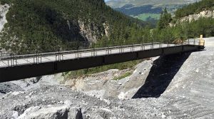 A dry support bridge deployed after severe flooding destroyed a road.