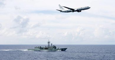 A RAAF P-8A Poseidon passes HMAS Darwin . Photo by Leading Seaman Peter Thompson.