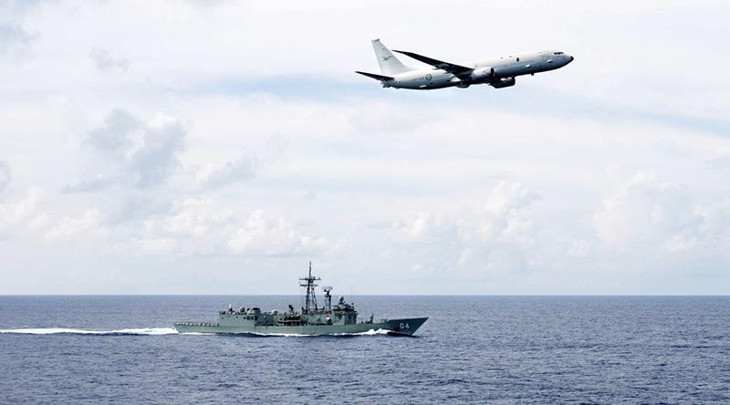 A RAAF P-8A Poseidon passes HMAS Darwin . Photo by Leading Seaman Peter Thompson.