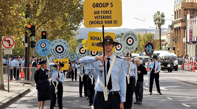 Leading Cadet Liam Mickan, No 613 Squadron, AAFC, carries the Banner at the head of the Air Force veterans of World War 2 for the Anzac Day march in Adelaide. He wore on his right breast the Zimbabwe Independence Medal awarded to his grandfather. Photo by Flying Officer (AAFC) Paul Rosenzweig.