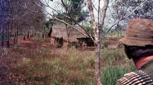 Big Julie and a hut on the edge of a rubber plantation.