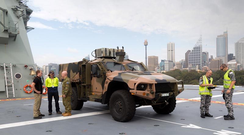 A Hawkei Protected Mobility Vehicle – Light on the flight deck of the Royal Australian Navy amphibious ship HMAS Adelaide during trials at Fleet Base East in Sydney. Photo by Leading Seaman Nicolas Gonzalez.