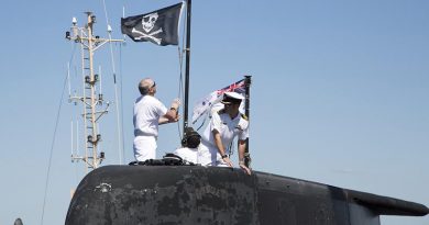 Executive Officer HMAS Dechaineux Lieutenant Commander Darren White raises the 'Jolly Roger' on Collins-class submarine HMAS Dechaineux at Fleet Base West. Official Defence photo by Chief Petty Officer Damian Pawlenko.