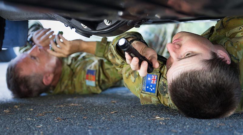 Australia Army Reserve soldiers Privates Zac Kelly (right) and Tony Duffy from 11 Brigade check underneath a vehicle during search training at Kokoda Barracks in preparation to support the security of the 2018 Gold Coast Commonwealth Games. Photo by Corporal Kyle Genner.