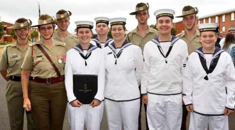 Seaman Siobhan von Prott, holding her graduation certificate, poses with, from left, Private Olivia Postlethwaite, mum Lieutenant Colonel Kim von Prott, brother (and Olivia’s partner) Private Angus von Prott, Leading Seaman Dylan Waters (fiancé of Molly von Prott, one of the non-military family members), sister Seaman Alexandria Cunningham, brother Private Fearghus von Prott, brother Cadet Leading Seaman Ethan von Prott, brother Private Hamish von Prott, and brother Cadet Recruit Robert von Prott at her graduation ceremony at HMAS Cerberus. Absent is Alexandria’s husband Leading Seaman Luke Cunningham, who sailed on HMAS Success the day the photo was taken.  Photo by Able Seaman Bonny Gassner Story by Corporal Sebastian Beurich