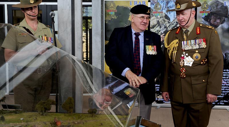 Bill Thurley shows Governor General of Australia General (Retd) Sir Peter Cosgrove a new diorama of the Battle of FSB Coral following a 50th anniversary parade at 1RAR. Photo by Major Al Green.