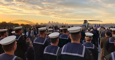 Royal Australian Navy personnel and guests listen to French President Macron onboard HMAS Canberra. Photo by Lieutenant Andrew Ragless.