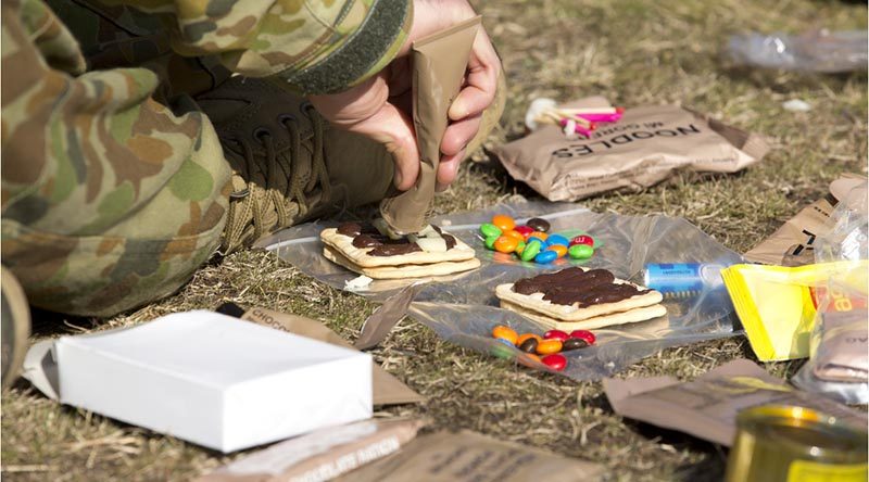 An Australian Army staff cadet from Royal Military College, Duntroon, combines some ingredients during a lecture on ration packs at the Majura training area. Photo by Corporal Bill Solomou.
