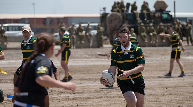 Australian and New Zealand members of Task Group Taji-6 compete in a game of modified rugby league to help raise money for charity on Anzac Day in Iraq.