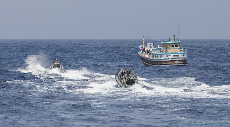 HMAS Warramunga crewmembers prepare to board a vessel suspected of carrying drugs. Photo by Leading Seaman Tom Gibson.