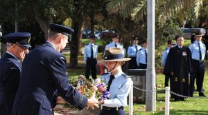 Wing Commander Mick Reidy, CO 462 Squadron, receives his floral tribute from Kelly Parkin of 613 Squadron AAFC, newly promoted to Cadet Corporal. Photo by Flying Officer (AAFC) Paul Rosenzweig.