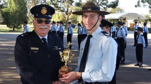 CSGT Benjamin Whiting (609 Squadron) receives the trophy for the Wing F-88 (WTSS) Team Shooting Competition.