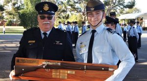 CSGT James Marchant accepts the trophy for the Wing .22” LR Team Shooting Competition, won by 622 Squadron for the third successive year.