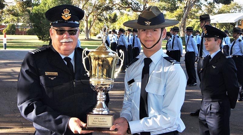 Cadet Corporal Nicholas Sibly accepts the Wing Inter-Squadron Drill Competition trophy on behalf of No 601 Squadron. Photo by Flying Officer (AAFC) Paul Rosenzweig