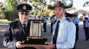 Cadet Sergeant Ben Whiting from No 609 Squadron (Warradale Barracks) receives the Catalina Cup Trophy from the Officer Commanding No 6 Wing, Wing Commander (AAFC) Peter Gill. 