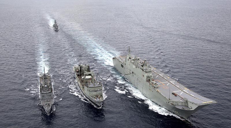 HMAS Success (centre) conducts a replenishment at sea with HMA Ships Adelaide and Melbourne, shadowed by HMAS Toowoomba, during Exercise Indo-Pacific Endeavour 2018. Photo by Able Seaman Tara Byrne.