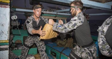 HMAS Warramunga boarding party members Able Seaman Corey Bartlett and Able Seaman Jacob Dun relocate parcels of seized narcotics. Photo by Leading Seaman Tom Gibson.