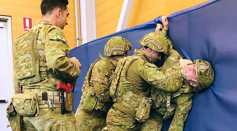 Under the watchful eye of an instructor, soldiers from the 1st Brigade practise subduing an enemy soldier during an Army Combatives Program training session at RAAF Edinburgh. 7RAR photo.