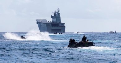 United States Marine Corps amphibious assault vehicles in Kaneohe Bay, Hawaii, prepare to enter HMAS Adelaide's well deck at sea during Exercise Rim of the Pacific 18. Photo by Corporal Kyle Genner.