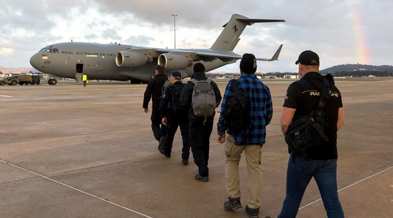 Australian Federal Police Specialist Response Group members and an official from Department of Foreign Affairs and Trade board a Royal Australian Air Force C-17A Globemaster at Canberra Airport to assist in the international search and rescue effort for children missing in a cave complex in Thailand. Photo by Sergeant Ray Vance.