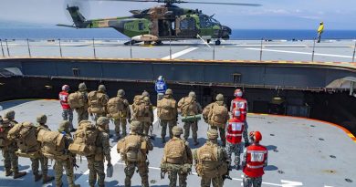 United States Marines prepare to board HMAS Adelaide's MRH-90 helicopter in support of amphibious operations off the coast of Hawaii, as part of Exercise RIMPAC 2018. Photo by Able Seaman Ronnie Baltoft.