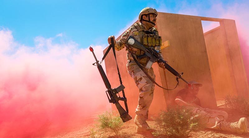 An Iraqi Army soldier disarms an enemy role player during a rehearsal of the Officer and Junior Leaders Course culminating activity at Taji Military Complex, Iraq. Photo by Corporal David Said.