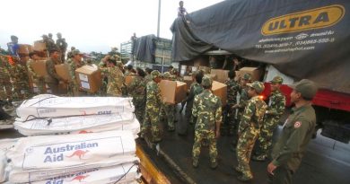 Laos Army personnel unload Australian Humanitarian Aid pallets that have been delivered to Pakse International Airport by a No. 36 Squadron C-17A Globemaster. Photo by Corporal Colin Dadd.