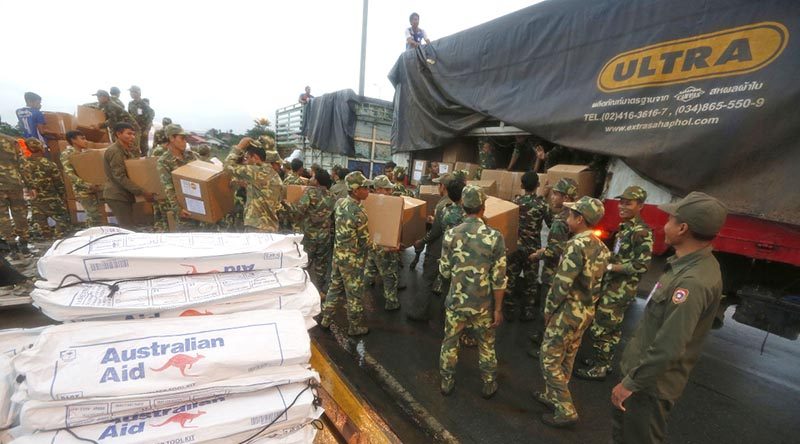 Laos Army personnel unload Australian Humanitarian Aid pallets that have been delivered to Pakse International Airport by a No. 36 Squadron C-17A Globemaster. Photo by Corporal Colin Dadd.