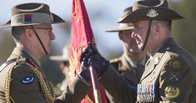 New Chief of Army Lieutenant General Rick Burr passes the Australian Army Banner to new Regimental Sergeant Major - Army, Warrant Officer Grant McFarlane. Photo by Corporal Tristan Kennedy.