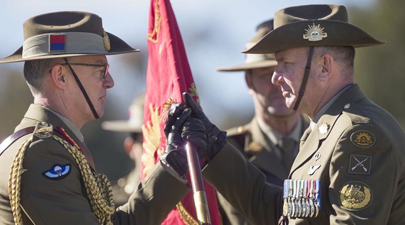 New Chief of Army Lieutenant General Rick Burr passes the Australian Army Banner to new Regimental Sergeant Major - Army, Warrant Officer Grant McFarlane. Photo by Corporal Tristan Kennedy.